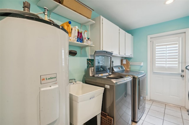 laundry area with cabinets, light tile patterned floors, water heater, washer and dryer, and sink