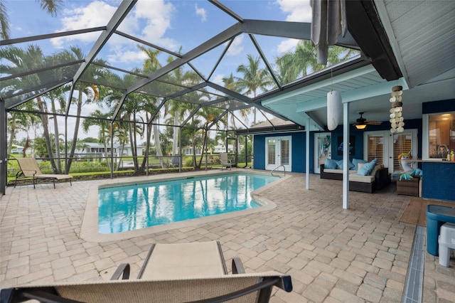 view of swimming pool featuring a lanai, a patio area, outdoor lounge area, and ceiling fan