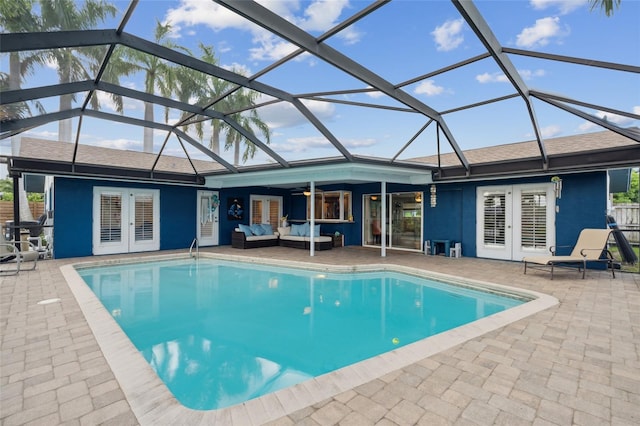 view of pool featuring a lanai, a patio, and french doors