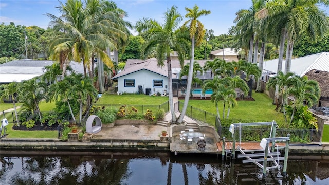 dock area featuring a water view and a lawn