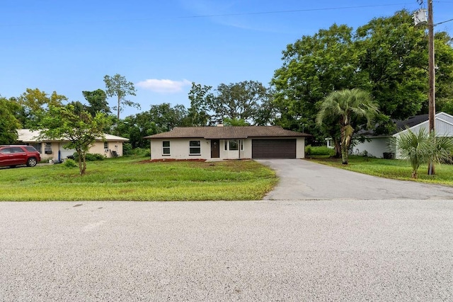 ranch-style home with a front lawn and a garage