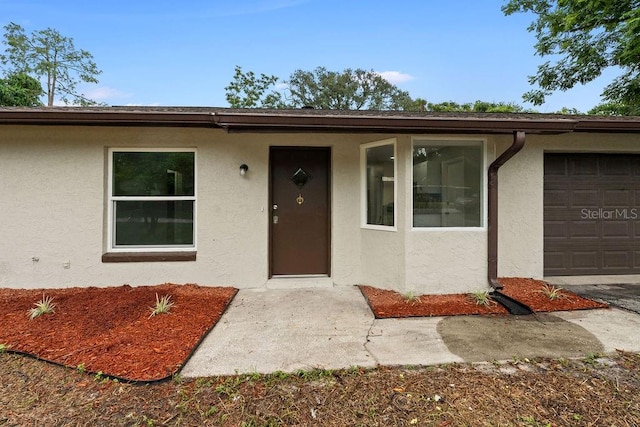 view of exterior entry featuring a garage