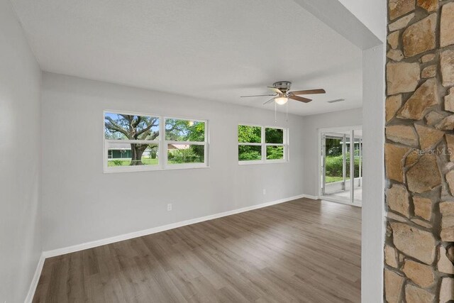 unfurnished room featuring ceiling fan and wood-type flooring