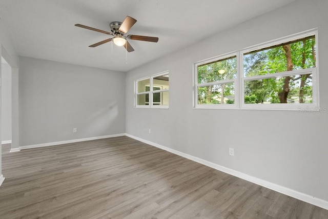 empty room with hardwood / wood-style flooring and ceiling fan