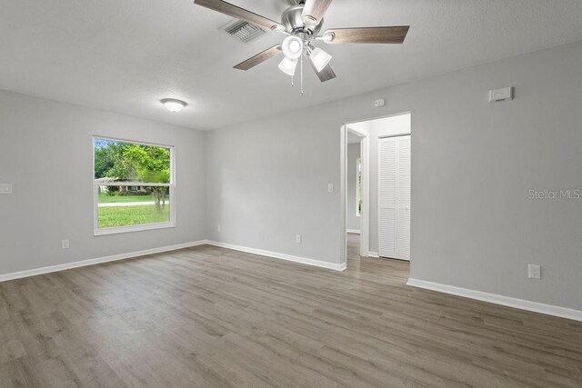 unfurnished room featuring hardwood / wood-style flooring and ceiling fan