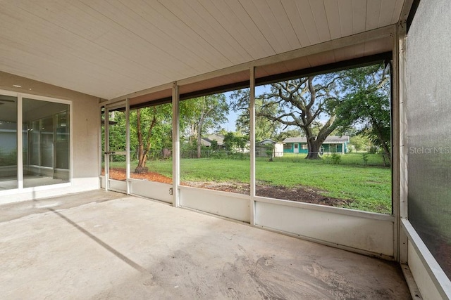 unfurnished sunroom featuring wood ceiling