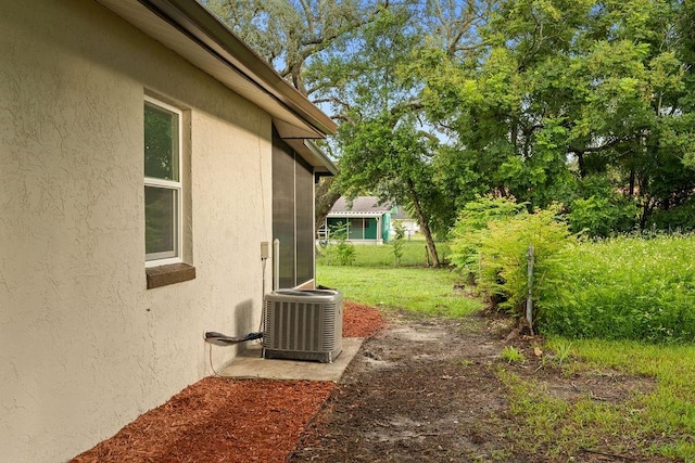 view of yard with central air condition unit