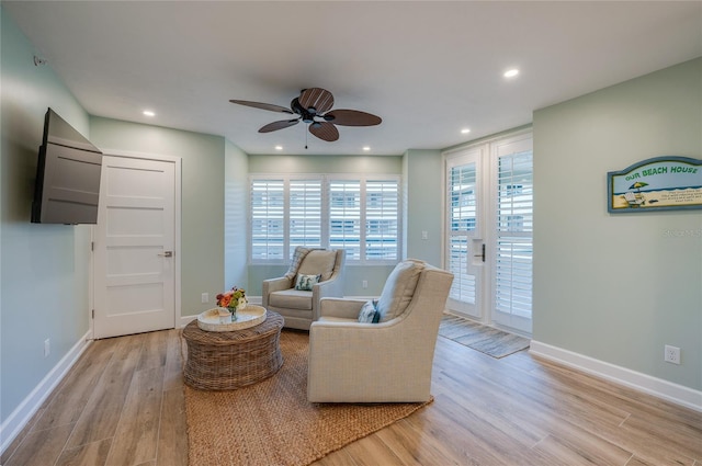 sitting room featuring light hardwood / wood-style flooring and ceiling fan