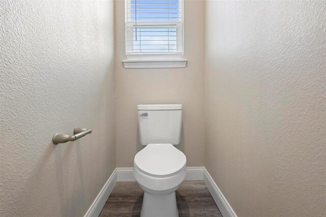 bathroom with toilet and hardwood / wood-style floors