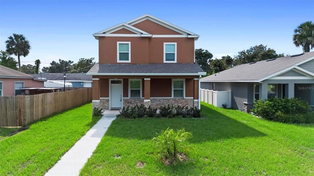 craftsman house with a front yard and a porch