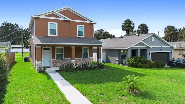 craftsman house with central AC unit, a garage, a front lawn, and covered porch