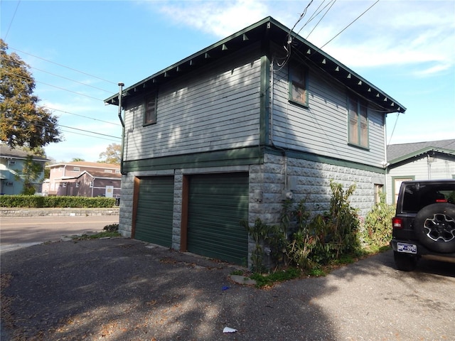 view of side of home featuring a garage