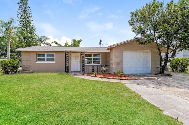 ranch-style home featuring concrete driveway, an attached garage, and a front yard