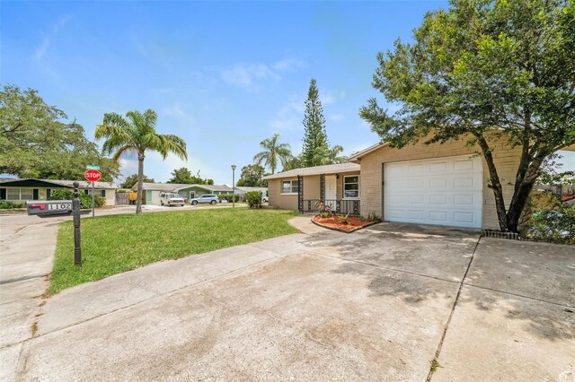 single story home featuring a garage and a front yard