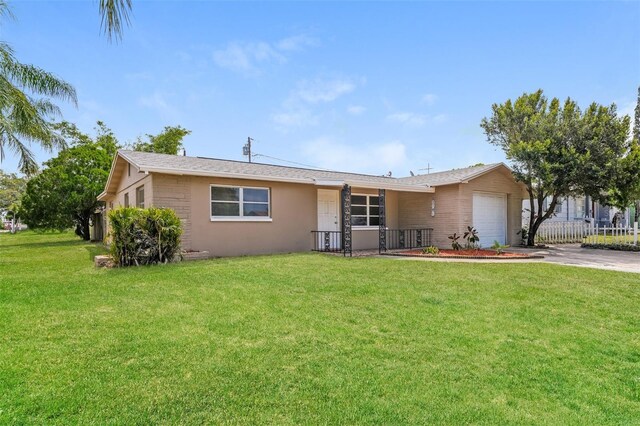 single story home with a garage and a front yard