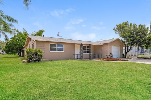 ranch-style home featuring an attached garage, driveway, and a front lawn