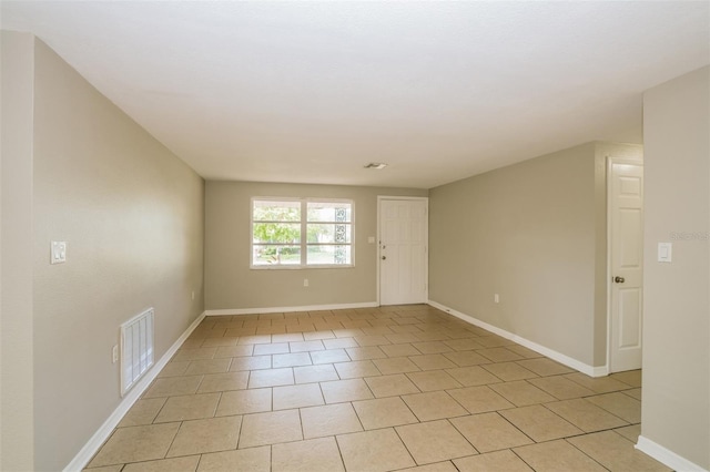 unfurnished room with visible vents and baseboards