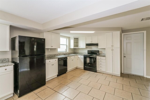 kitchen featuring light stone countertops, black appliances, light tile patterned floors, sink, and white cabinets