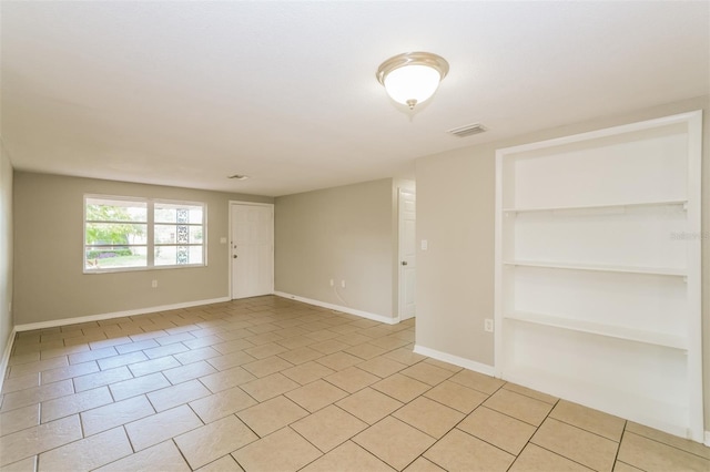 unfurnished room with light tile patterned floors