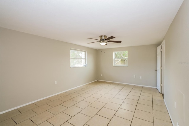 empty room with baseboards and a ceiling fan