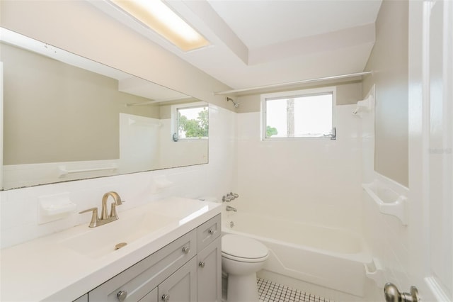 bathroom with tile patterned flooring, toilet, vanity, shower / tub combination, and tile walls