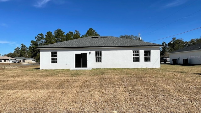 rear view of property with a yard