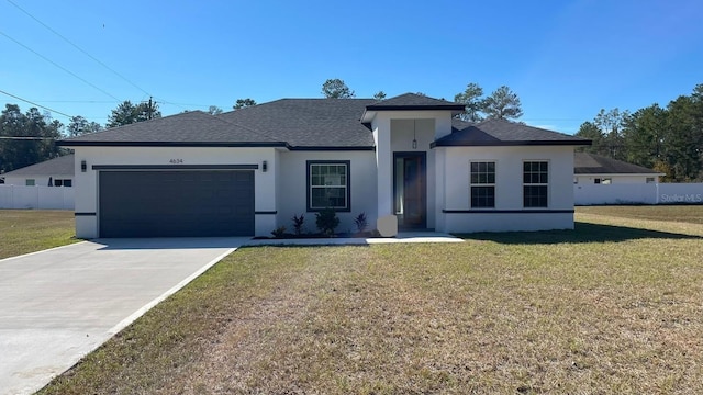 view of front of property featuring a front lawn and a garage