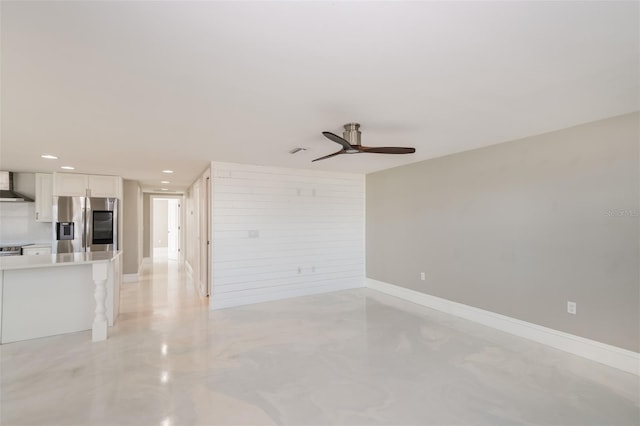 unfurnished living room featuring ceiling fan