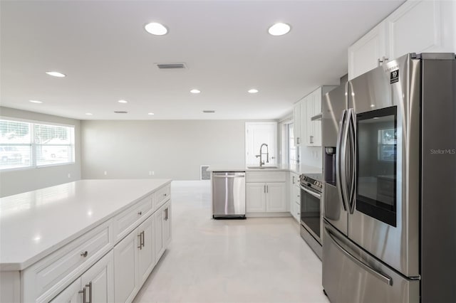 kitchen featuring white cabinetry, stainless steel appliances, and sink