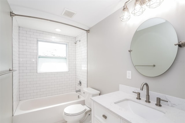 full bathroom featuring tiled shower / bath, toilet, and vanity