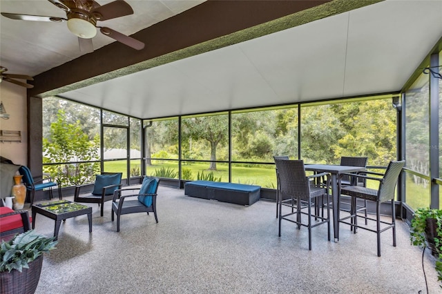 sunroom / solarium with ceiling fan and a healthy amount of sunlight