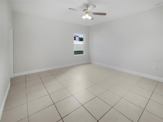 empty room featuring ceiling fan and light tile patterned floors