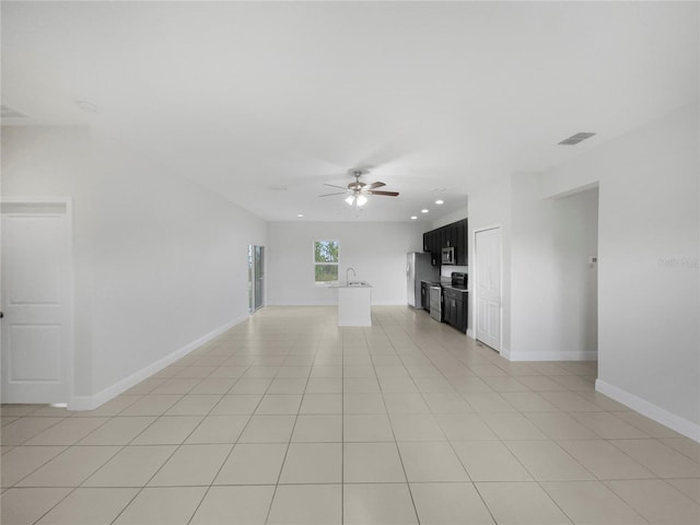 unfurnished living room featuring light tile patterned floors and ceiling fan