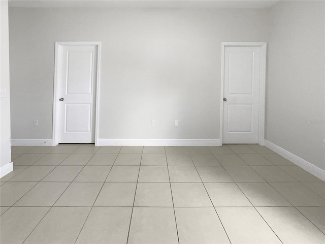 unfurnished room featuring light tile patterned flooring