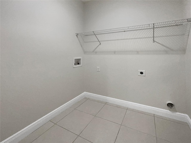 washroom with washer hookup, electric dryer hookup, and light tile patterned flooring