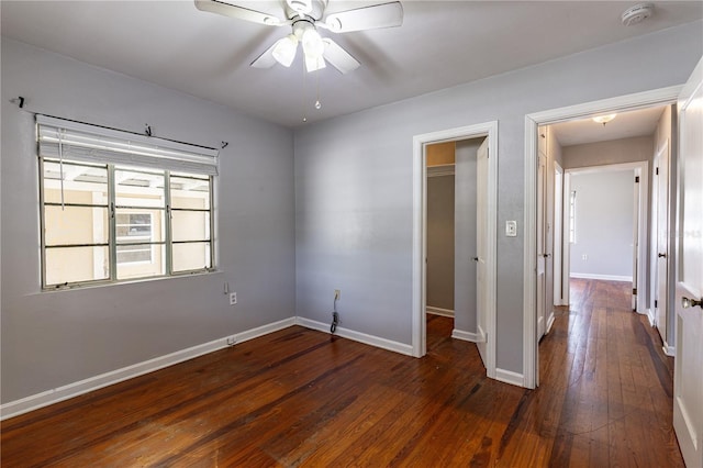 spare room with dark hardwood / wood-style flooring and ceiling fan