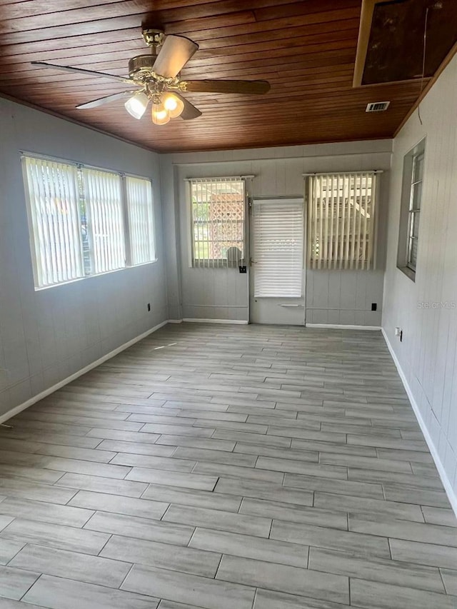 unfurnished room featuring light wood-type flooring, ceiling fan, and wooden ceiling