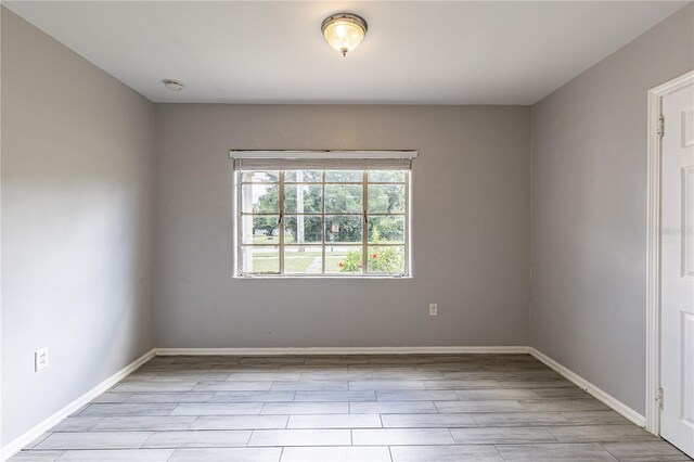 unfurnished room with light wood-type flooring