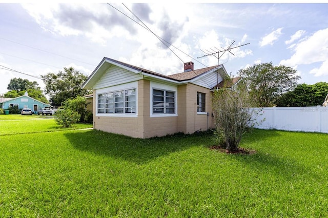 view of side of home featuring a yard