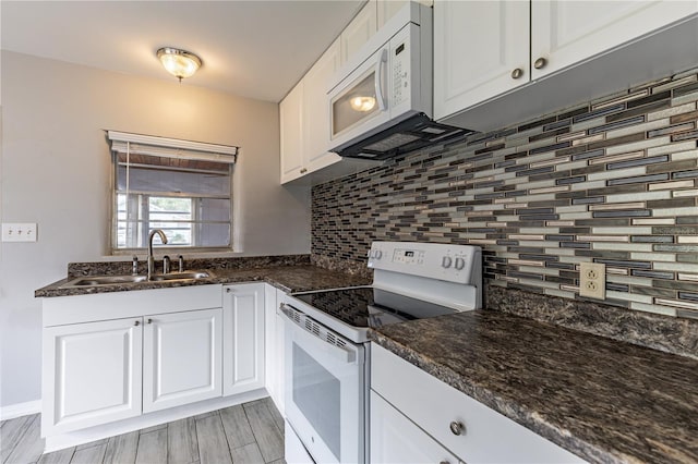 kitchen with backsplash, white appliances, sink, and white cabinets