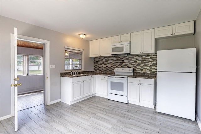 kitchen with light hardwood / wood-style floors, white cabinetry, sink, tasteful backsplash, and white appliances