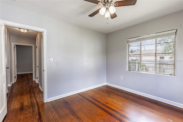 spare room featuring ceiling fan and dark hardwood / wood-style flooring