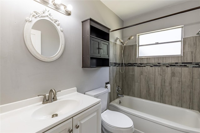 full bathroom featuring vanity, tiled shower / bath combo, and toilet