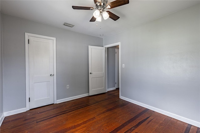 unfurnished bedroom featuring dark wood-type flooring and ceiling fan