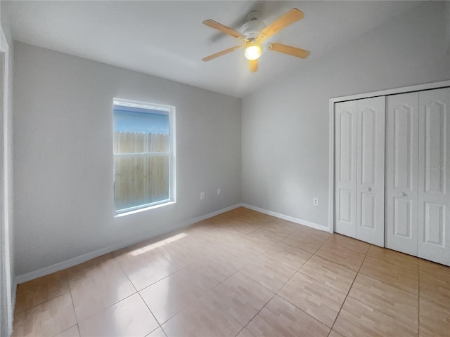 unfurnished bedroom featuring light tile patterned floors, ceiling fan, and a closet