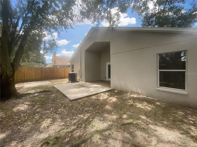 back of house with cooling unit and a patio area