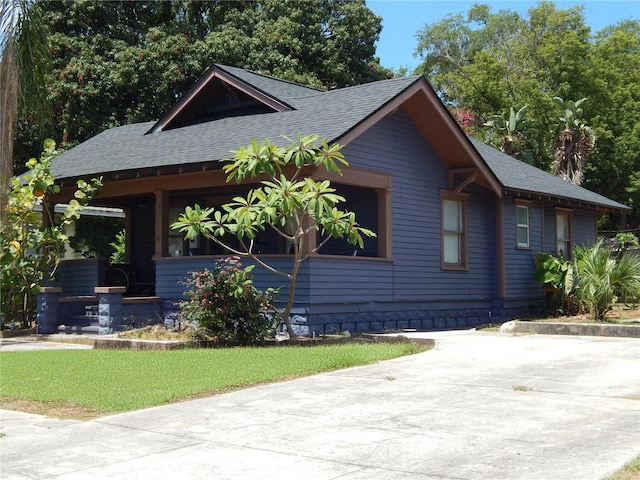 view of front facade featuring covered porch and roof with shingles