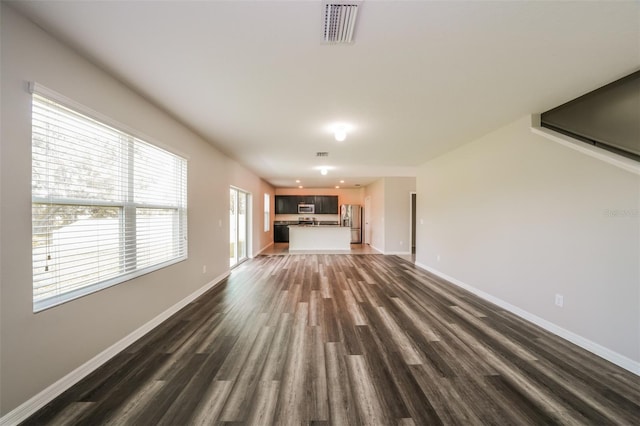 unfurnished living room featuring dark wood-type flooring