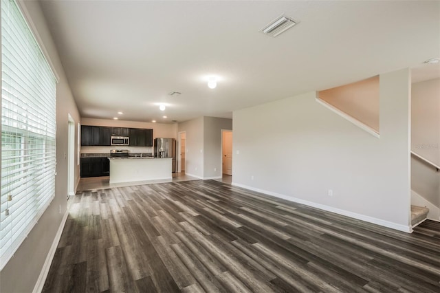 unfurnished living room with dark hardwood / wood-style floors