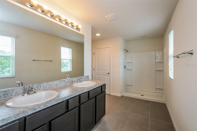 bathroom featuring vanity, walk in shower, and tile patterned flooring